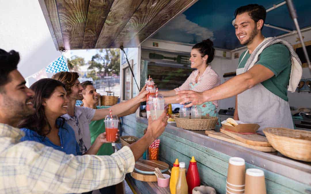 food truck waitress and waiter giving juice to customer