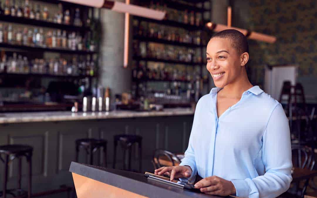 online ordering female owner of restaurant bar standing at counter