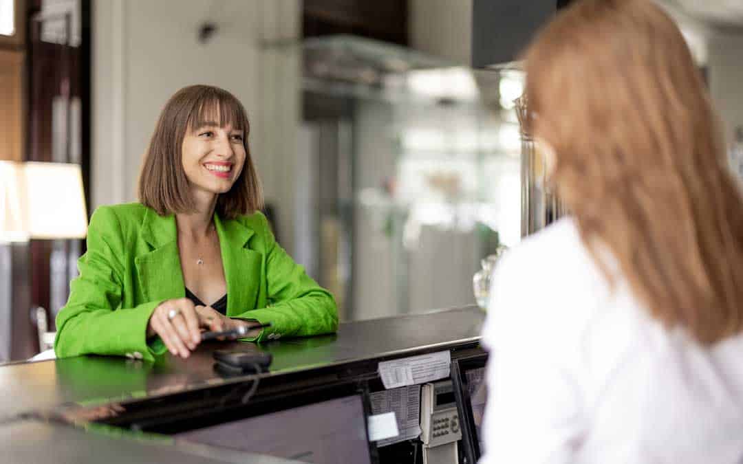 business woman pays at the hotel reception