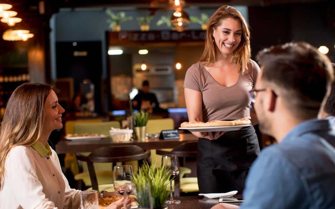 pizza waiter woman serving group of friends with pizza